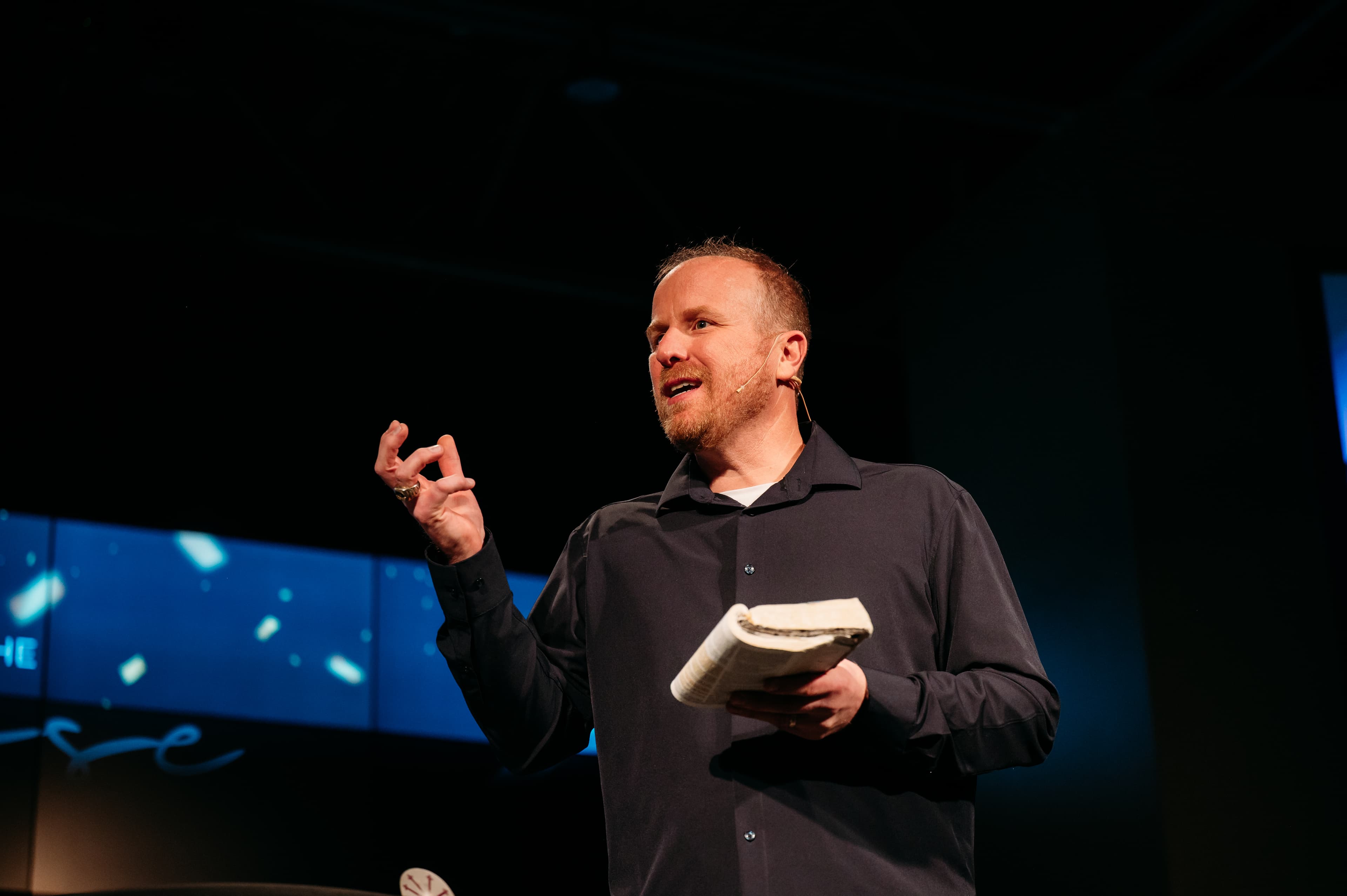 Joshua P. Underbakke speaking with Bible in hand
